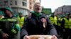 Romanian farmers gather in front of the European Commission headquarters in Bucharest on April 7 to protest against insufficient compensation from EU funds after the complete elimination of customs duties on all goods from Ukraine since the middle of last year. 