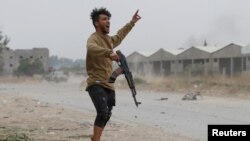 A fighter loyal to Libya's UN-backed government during a clash with forces loyal to Khalifa Haftar on the outskirts of Tripoli.
