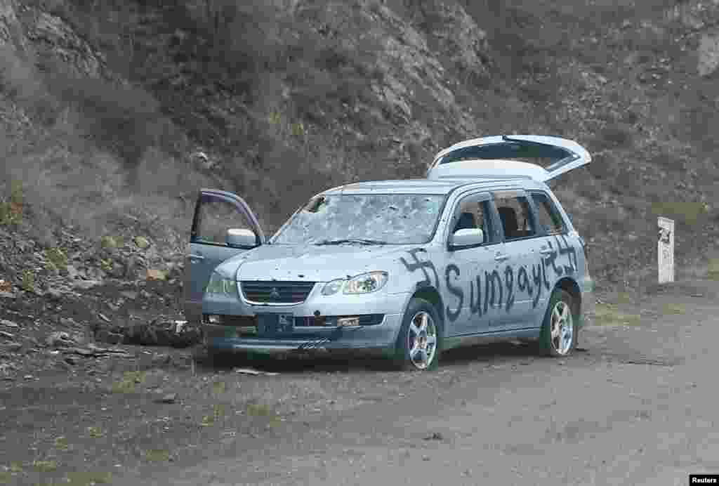 A car spray-painted with swastikas and the word "Sumqayit." The Azerbaijani town of Sumqayit was the scene of an infamous massacre in 1988, when dozens of ethnic Armenians were killed amid unrest over Nagorno-Karabakh. 