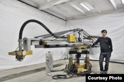 Apis Cor founder Nikita Chen-yun-tai with his company's revolutionary 3D-printer equipment.