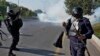 Pakistani police fire tear gas toward protesters marching toward Islamabad on November 26.