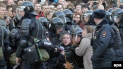 Russian riot police detain a demonstrator during an opposition rally in central Moscow on March 26.