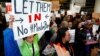 Dulles Dispatch: Protesters Greet Travelers With Smiles As Confusion Persists Over U.S. Travel Ban