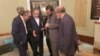 Iran's foreign minister, Abbas Araqchi (second left), and other members of the Iranian delegation confer at the talks in Muscat on April 12. 