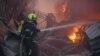 Firefighters work at the site of an office building hit by a Russian missile strike in Kyiv early on April 6.