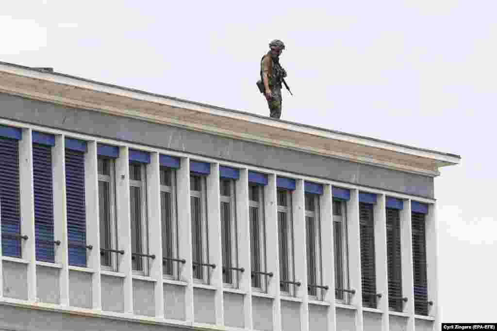 A soldier stands on the roof of a building near Geneva airport on June 15. 