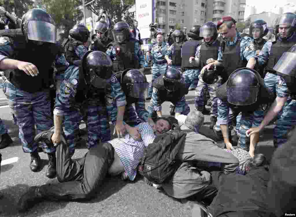 Riot police arrest Orthodox Christian activists trying to prevent the march. 