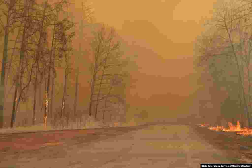 Smoke and flames gave the forest in the exclusion zone an eerie orange glow on April 10. Officials with Ukraine's Emergency Situations Service said that radiation in the region and in the capital, Kyiv, was within "permissible" levels.