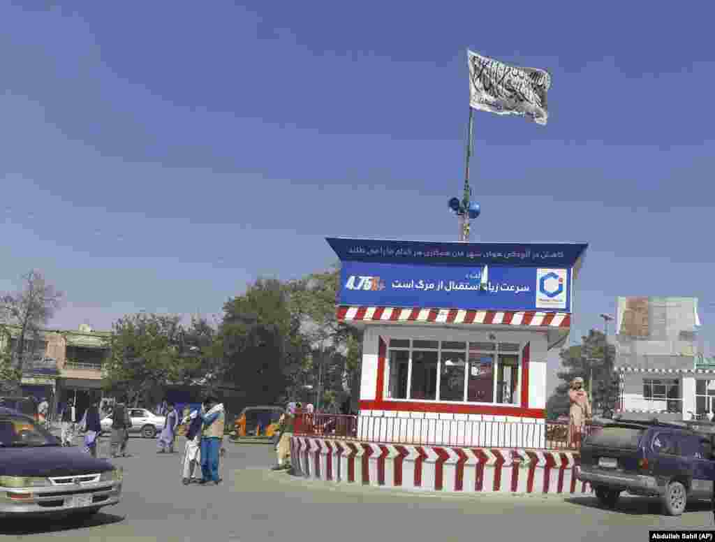 A Taliban flag flies on the main square of the city of Kunduz after fighting between Taliban and Afghan security forces. Government forces in Kunduz appeared to be only in control of the airport and their own base, with all key government buildings in the city in the militants' hands. The main prison in Kunduz was also reportedly under Taliban control. 