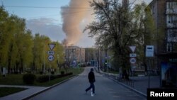 A man crosses a street near the site of a Russian drone attack in Kyiv on April 12. 
