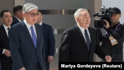 Qasym-Zhomart Toqaev (left) and Nursultan Nazarbaev attend the Astana Economic Forum in Nur-Sultan in May.