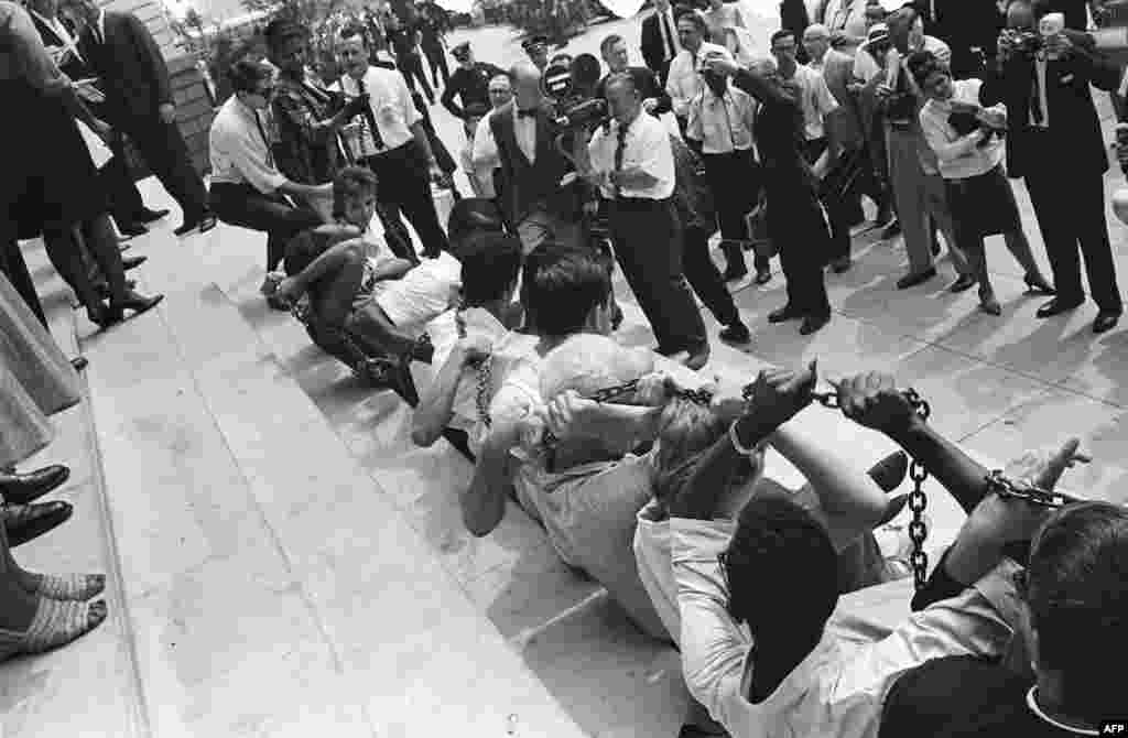Black and white protesters chain themselves together during a protest against segregation in front of New York City Hall on August 23, 1963.