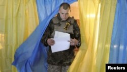 A Ukrainian serviceman after casting his vote in parliamentary elections at a polling station in Novoaidar near Luhansk on October 26. 