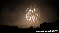 A photo shows what appears to be white phosphorus incendiaries landing during Syrian bombardment in Douma last month.