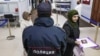 RUSSIA, NOVOSIBIRSK - MAY 31, 2024: A police officer and foreign nationals are seen at a migration service centre. 