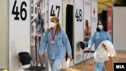 Workers at a vaccination center in Skopje. North Macedonia.