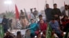 Maryam Nawaz Sharif, center, in blue dress, a leader of the Pakistan Democratic Movement, waves to her supporter during an anti-government rally in Multan, Punjab, on November 30.
