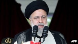 Iranian President Ebrahim Raisi attends a military parade alongside high-ranking officials and commanders during a ceremony marking the country's annual National Army Day in Tehran on April 17. 