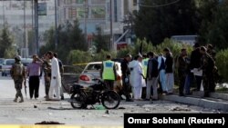 Afghan security forces inspect the site of a suicide attack in Kabul on September 9.