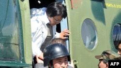 Interim leader Roza Otunbaeva exits her helicopter upon arrival in Osh on June 18.