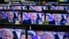 TV screens showing Russian President Vladimir Putin during an annual nationwide Q&A on April 16.