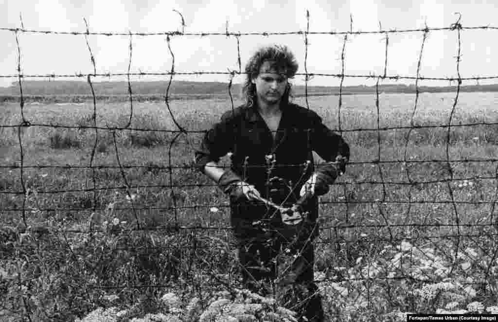 A worker cuts the fence between Hungary and Austria. In May 1989, a 240-kilometer-long fence along Hungary’s border with Austria was deemed more trouble than it was worth. The expensive barrier was equipped with sensors designed to detect people fleeing into the West but by 1989 the fence was increasingly problematic. Automated alarm rockets were being triggered by wild animals, or nothing at all. 