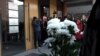 Students hold white flowers at a court building in Belgrade ahead of the sentencing of the parents of a boy who killed 9 students and security guard in a school shooting in 2023.
