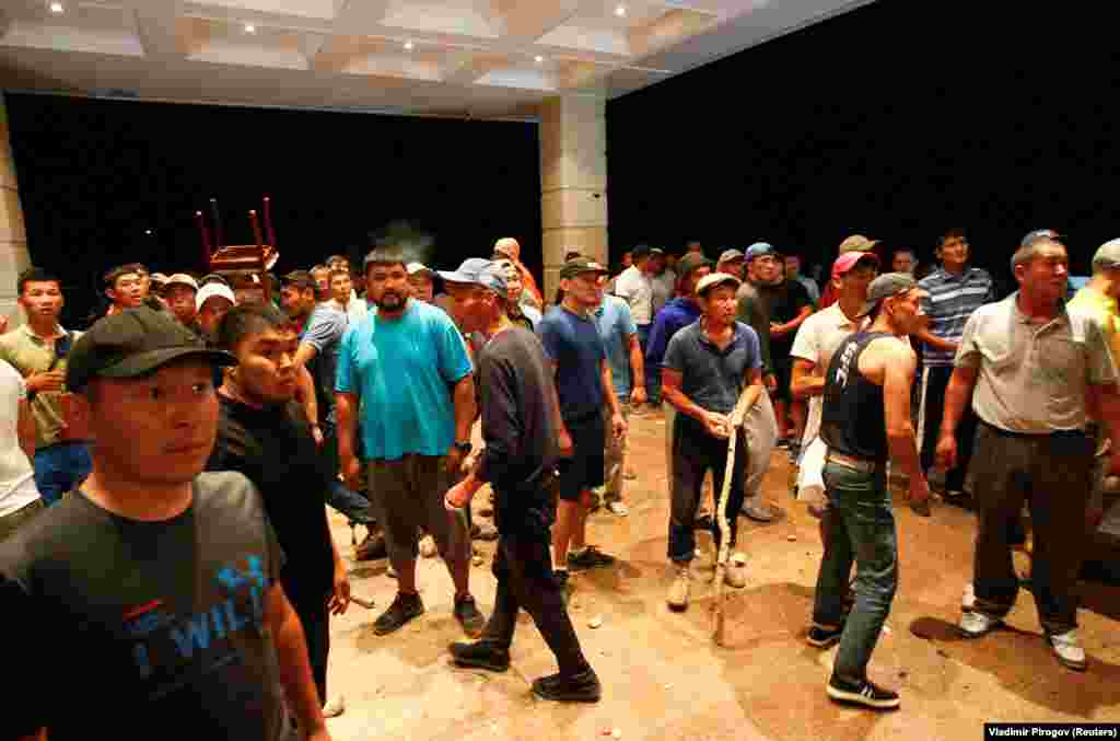 Supporters gather at the entrance to a building in the compound. 