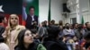 Volunteers for former Prime Minister Imran Khan's party, Pakistan Tehrik-e-Insaf (PTI), look on as they watch election results on TV screens in Islamabad on February 8.