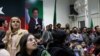 Supporters of former Prime Minister Imran Khan's Pakistan Tehreek-e-Insaf (PTI) party look on as they watch results on TV screens in Islamabad on February 8.
