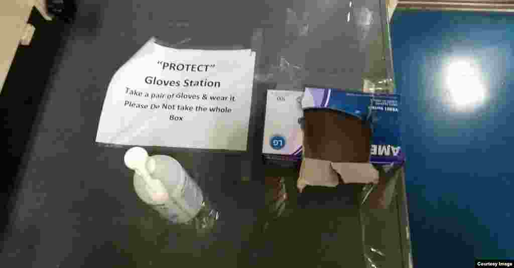 Hand sanitizer and an empty box of rubber gloves. Such stations are dotted throughout the vessel.&nbsp;