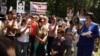 Глава НПО "Аман-саулык" Бахыт Туменова (справа) выступает на митинге. Алматы, 31 мая 2012 года.
