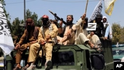 Taliban fighters celebrate the third anniversary of the withdrawal of U.S.-led troops from Afghanistan in Kabul last month. 