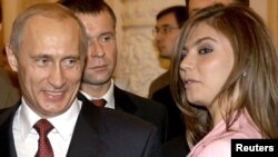 Russian President Vladimir Putin (left) smiles next former Russian gymnast and former Duma deputy Alina Kabayeva, with whom he has been romantically linked. According to the Reuters news agency Kabayeva was implicated in a report on alleged connections between a shadowy Putin-connected businessman and several women in the president's life. 