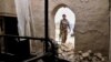 AFGHANISTAN -- An Afghan security official inspects the scene of a suicide bomb attack in Kandahar, December 7, 2020