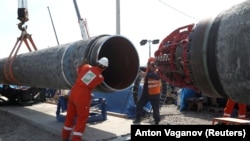 Workers are seen at the construction site of the Nord Stream 2 gas pipeline near the town of Kingisepp in Russia's Leningrad region.