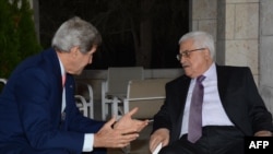 U.S. Secretary of State John Kerry (left) meets with Palestinian leader Mahmud Abbas at a hotel in Amman on July 16.
