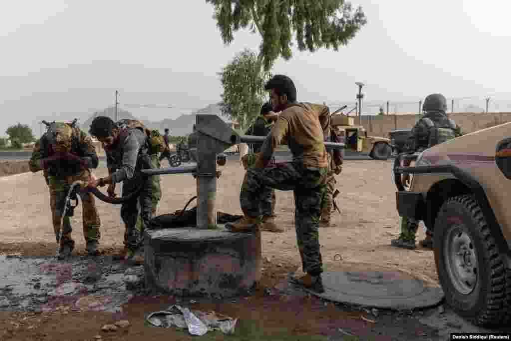 The battle-weary fighters freshen up at their base after the July 13 rescue mission. The dangerous assignment came at dawn, just minutes after the elite soldiers had returned to their base from a late-night mission. 