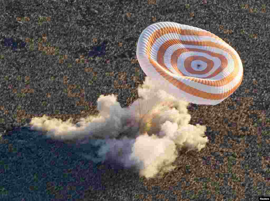 A "Soyuz" TMA-09M capsule carrying the ISS crew of Karen Nyberg, Fyodor Yurchikhin, and Luca Parmitano lands in a remote area near the town of Zhezkazgan, Kazakhstan, in November 2013. The three returned to Earth with an Olympic torch that was displayed in open space as part of Russia's preparations for the Sochi 2014 Winter Games.