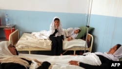 Schoolgirls lie in a hospital with symptoms of gas poisoning in Charikar, Afghanistan May 2009.