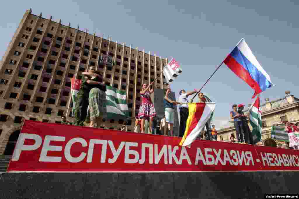 In the first major crisis of Medvedev's presidency, Russia fought a five-day war with Georgia over the breakaway Georgian territories of Abkhazia and South Ossetia. In this photo from August 26, 2008, people in Sukhumi wave flags as they celebrate Moscow's recognition of the territories as independent states. 