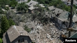 Police experts work at the site of the Russian air strike in Zaporizhzhya, Ukraine, on June 9.