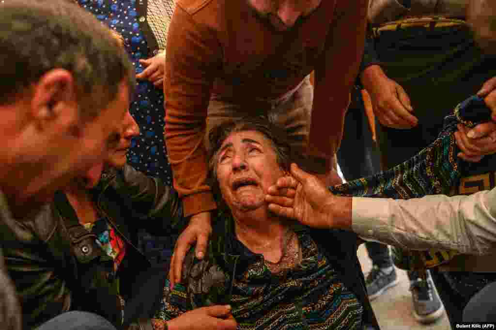 Relatives of Royal Sahnazarov, Zuleyha Sahnazarova, and their daughter Medine Sahnazorava, who were killed when a rocket hit their home in Ganca, mourn during their funeral on October 17. 
