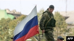 Russian atop a military vehicle in Tskhinvali, the South Ossetian capital, on August 29, 2008
