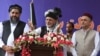 President Ashraf Ghani (center) stands with Amrullah Saleh (right), his vice presidential candidate, during his election campaign stop in Jalalabad on September 20.