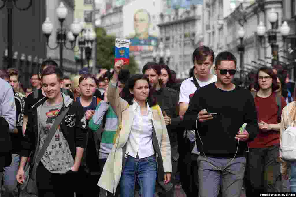 A protester holds aloft a copy of Russia's constitution, which guarantees freedom of assembly and free speech. 