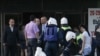 Russia -- Russian Emergency Ministry servicemen help an injured woman aftern explosion in Stavropol, 26May2010
