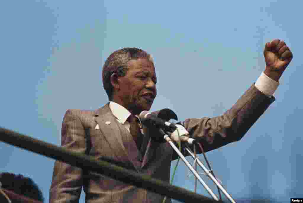 Nelson Mandela raises his fist to the crowd while making a speech in Port Elizabeth shortly after his release in 1990.