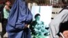 Supporters carry portraits of Burhanuddin Rabbani during a gathering in Kabul to remember him.