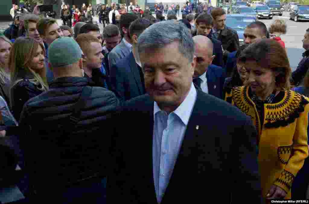 Incumbent President Petro Poroshenko speaks to RFE/RL as he arrives at Kyiv&#39;s House of Officers to cast his ballot with his wife, Maryna Poroshenko, on April 21.